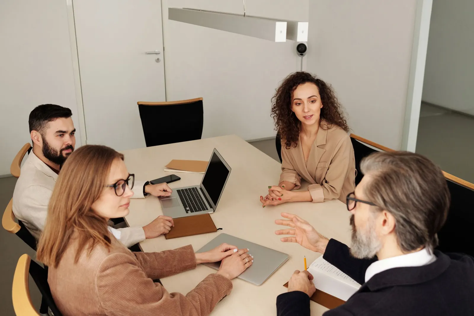 A small team in discussion around a meeting table