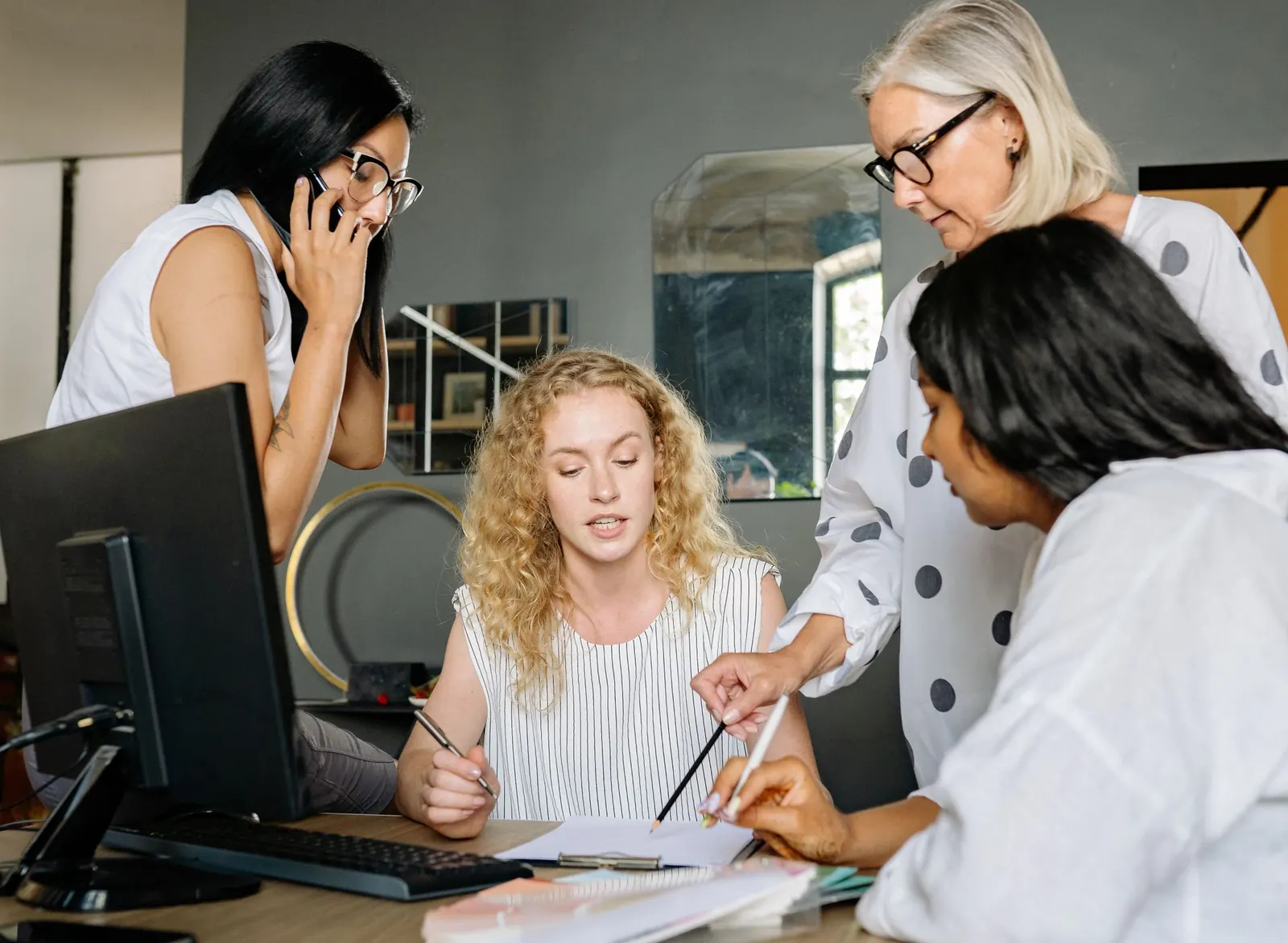 Colleagues working through notes and charts at a shared desk